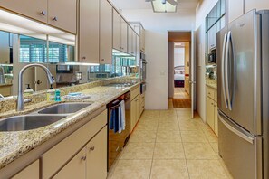 A modern kitchen with granite countertops, stainless steel appliances, and a walk-in pantry. - Iconic mid-century modern home with on-site pool access, grill, AC, & W/D (Palm Desert)