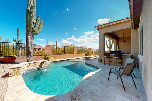 Southwestern stunner with enclosed yard, pool, putting green, & grill