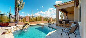 Southwestern stunner with enclosed yard, pool, putting green, & grill