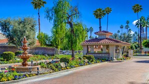A landscaped area with a fountain, palm trees, and a gazebo. - Gated resort condo with outdoor pool, hot tub, & tennis - walk to dining (Palm Springs)