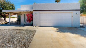 A modern house with a garage, a covered patio, and a gravel driveway. - Recently Updated Home w/ Private Patios: 15 Mins From Downtown Palm Springs (Desert Hot Springs)