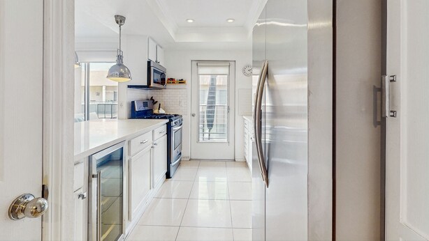 A modern kitchen with white cabinetry, stainless steel appliances, and a bright, well-lit space. - Dog-friendly condo w/ balcony & shared pools/hot tubs - close to downtown (Palm Springs)