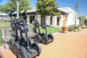 A row of Segway scooters parked outside a building with a sign that reads "TRAILSHED."
