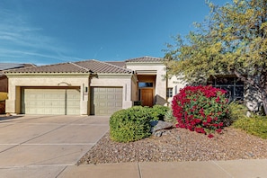 A residential house with a garage, a front door, and a landscaped garden with shrubs and a tree. - Dog-friendly home w/outdoor pool & firepit, near the top of South Mountain (Phoenix)