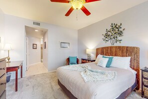 A bedroom with a large bed, a ceiling fan, a wall-mounted plant, and a bedside table with a lamp. - Luxury condo w/ shared hot tub, pool & tennis - close to golf & more (Scottsdale)