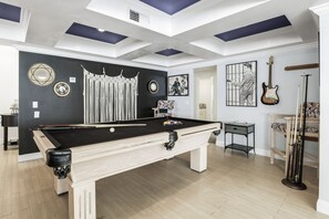 A pool table in a room with a high ceiling, decorative wall art, and a guitar. - Sunshine, Style & Your Own Private Pool Retreat – Dog-Friendly!- #112181 (La Quinta)
