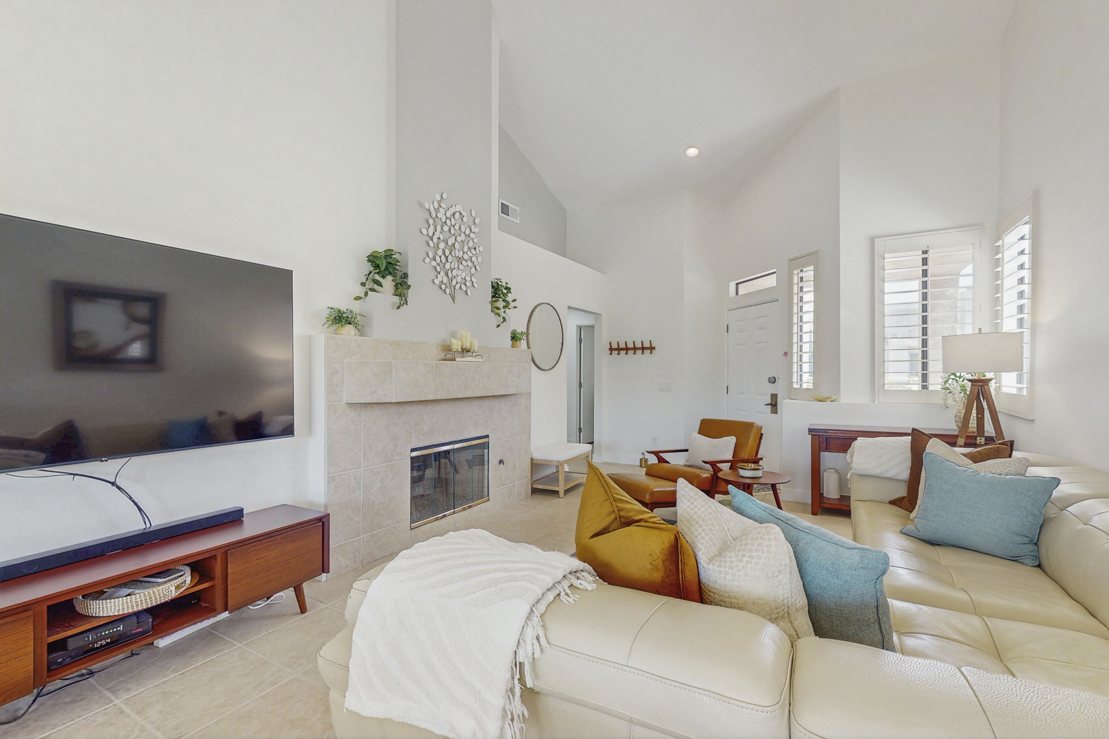 A spacious living room with a fireplace, a sofa, and a television.
