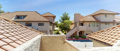 A residential area with houses featuring tiled roofs and a clear sky.