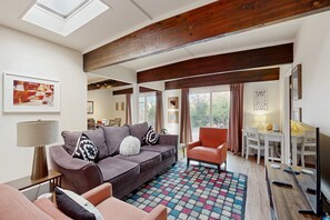 A living room with a sofa, armchairs, a coffee table, a TV, and a patterned rug. - Red Rock views & relaxation await at this charming Sedona escape (Sedona)