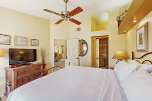 A hotel room with a bed, a television, a dresser, and a ceiling fan. - Classic and comfortable condo with pool, hot tub, & tennis (Tucson)