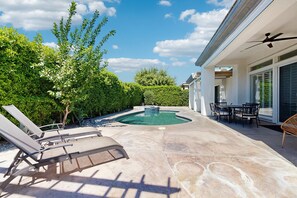 A backyard with a swimming pool, lounge chairs, and a dining area. - Quiet Dog-Friendly Desert Getaway w/ Private Pool, Spa & Mountain Views (Palm Desert)