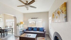 A living room with a sofa, coffee table, and fireplace.