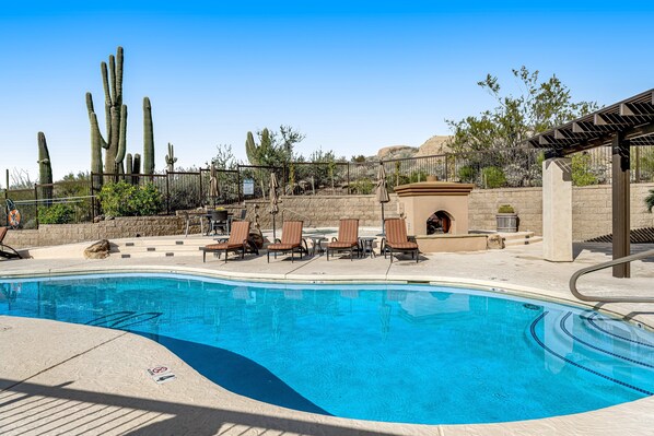 A swimming pool with lounge chairs, cacti, and a pergola. - Golf-Course View Condo with Central AC & Washer/Dryer - Shared Pool & Hot Tub (Scottsdale)