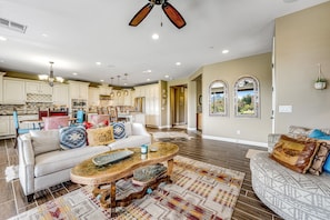 A spacious living area with a sofa, coffee table, and patterned rug. - Golf-Course View Condo with Central AC & Washer/Dryer - Shared Pool & Hot Tub (Scottsdale)