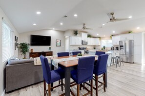 A modern kitchen with white cabinets, a built-in microwave, and a stainless steel refrigerator. - Modern Ranch with Private Putting Green, Fast WiFi, Central AC, & Great Location (Scottsdale)