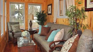 A cozy living room with a sofa, armchairs, a coffee table, and a potted plant. - Mapleview - Three Bedroom Cottage, Sleeps 12 (Cloyne)