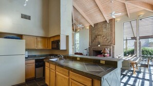 A kitchen with wooden cabinets, a stone countertop, and a built-in oven.