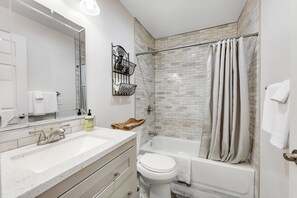 A bathroom with a white sink, a toilet, and a bathtub. - Ideally located, updated home near downtown with yard & washer/dryer (Flagstaff)