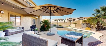 Spacious home surrounded by palms with pool, grill, children's items, & W/D