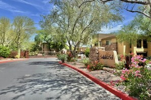 A gated entrance with a sign, surrounded by trees and landscaping. - Scottsdale Serenity: Your Stylish Desert Retreat with Stunning Views and Endless (Scottsdale)