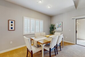 A dining area with a table, chairs, a plant, and artwork on the walls. - Scottsdale Serenity: Your Stylish Desert Retreat with Stunning Views and Endless (Scottsdale)