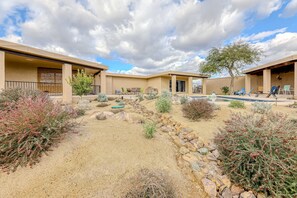 A resort with a pool, outdoor seating, and a desert garden.