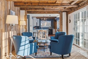 A cozy living room with blue armchairs, a coffee table, and a fireplace. - Spacious Farmhouse Near the Beach Circa 1860 (Biddeford)