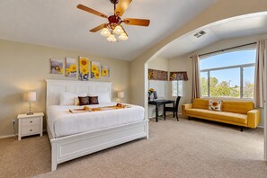 A bedroom with a bed, a desk, a chair, a yellow sofa, and a ceiling fan. - Beautiful home with private pool, W/D, central AC & great locale - dog-friendly (Mesa)