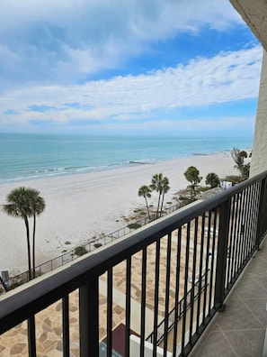 Ein Balkon mit Blick auf Strand und Meer.