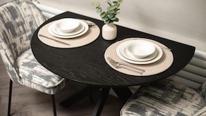 A dining table with two sets of white plates and cutlery, accompanied by woven placemats and a small potted plant. - Edinburgh Apartment - Sleeps 2 - Royal Mile Close (Edinburgh)
