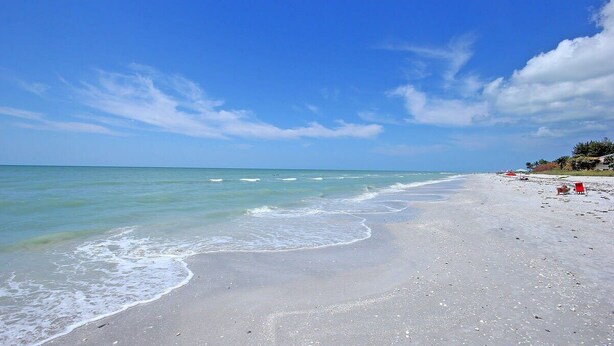 A beach with clear skies and calm waters. - Island Beach Club 240F | Exquisite Oceanfront Residence | Sun, Sea and Sand (Sanibel)