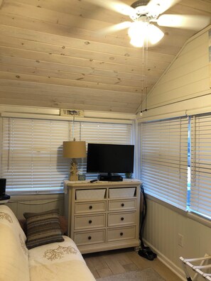 A room with a bed, a TV on a dresser, a ceiling fan, and a sign that says "WELCOME". - Perfect 2-bedroom plus sleeping porch house with AC in peaceful sleeps 6 (Lavallette)