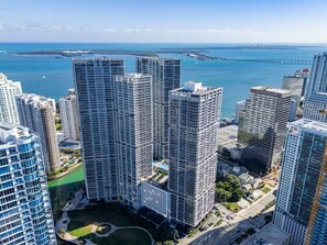 A high-rise building complex with multiple skyscrapers, a marina, and a bridge in the background. - Sky-High Water Views | Icon Brickell 2BR (Miami)