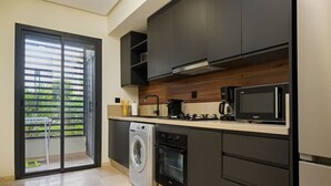Eine moderne Küche mit Waschmaschine, Mikrowelle und Kaffeemaschine.