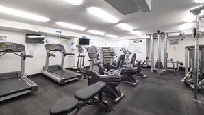 A gym with treadmills, elliptical machines, and weight equipment. - 29th floor ocean view Waikiki Hawaiian Monarch (Honolulu)