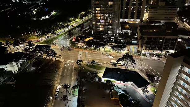 A nighttime aerial view of a city intersection with buildings, roads, and traffic. - 29th floor ocean view Waikiki Hawaiian Monarch (Honolulu)