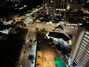 A nighttime aerial view of a city intersection with buildings, roads, and traffic. - 29th floor ocean view Waikiki Hawaiian Monarch (Honolulu)