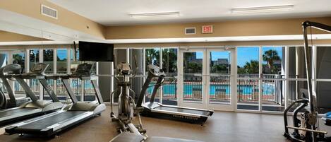 A gym with treadmills, a stationary bike, and a weight bench.