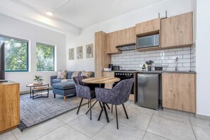 A modern kitchen with wooden cabinets, a built-in microwave, and a stainless steel refrigerator. - Circa Luxe Retreat • Serene Pool Views (Johannesburg)