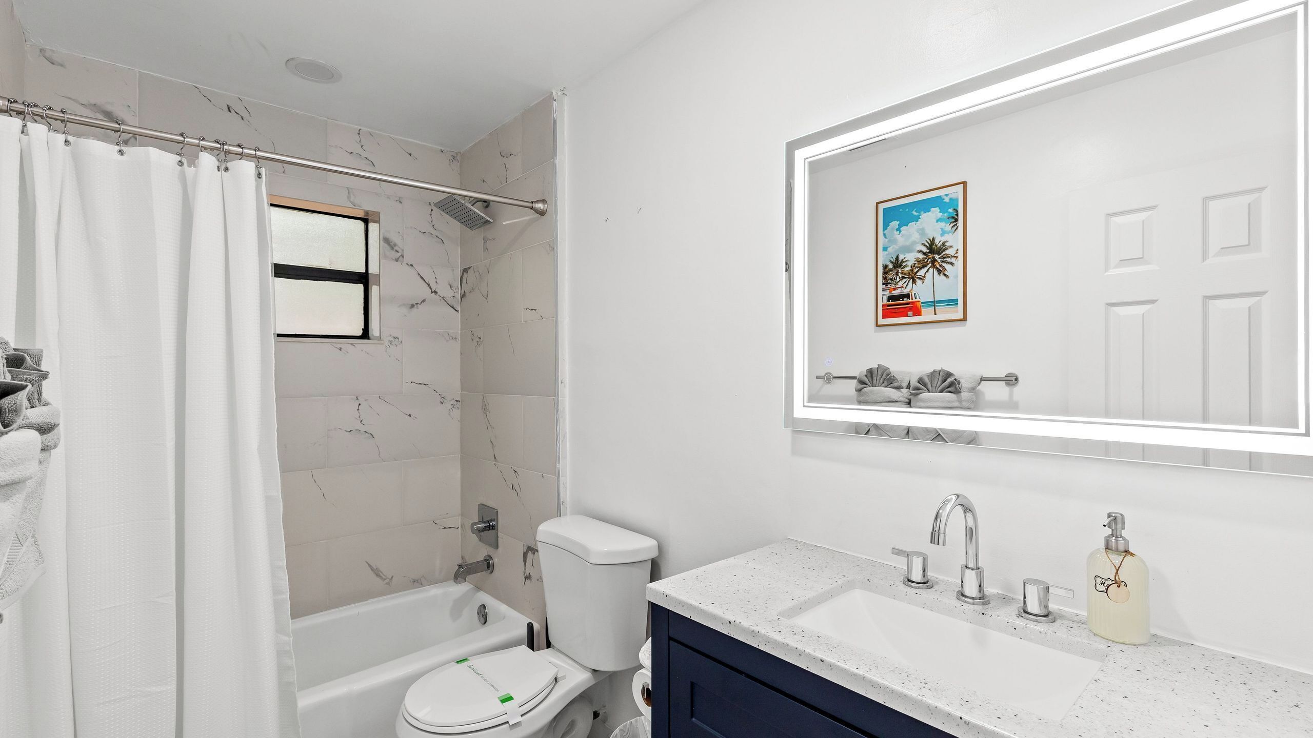 A bathroom with a bathtub, toilet, and sink.