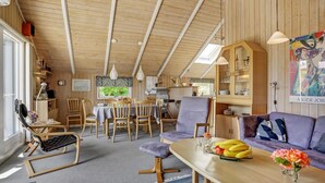 A cozy wooden interior with a dining area, seating, and a kitchen. - 3 bedroom beautiful home in Hejls (Hejls)