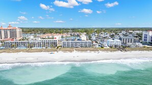 A coastal town with beachfront hotels, a sandy beach, and ocean waves. - Renovated 3-Bedroom Condo, Large Pool, Beach Access & Views! (North Myrtle Beach)