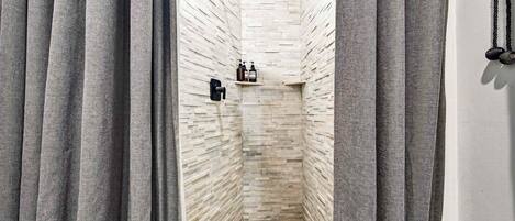 Shower, hair dryer, towels, shampoo
