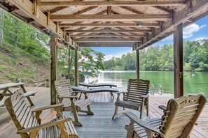 A wooden deck with benches overlooking a lake. - Reel Relaxed - Lakefront w/ Private Dock! (Moneta)