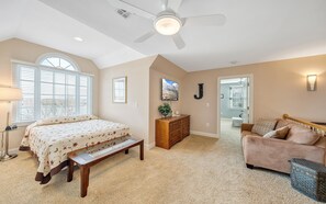 A bedroom with a bed, a bench, a dresser, a chair, and a ceiling fan. - Lake Lookout - Private Home With Lake Views & Game Room (Moneta)