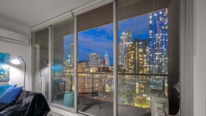 A room with a large window overlooking a cityscape at night. - Convenient CBD Retreat in the Best Location! 2 Bed | 2 Bath | 2 Parking (Melbourne)