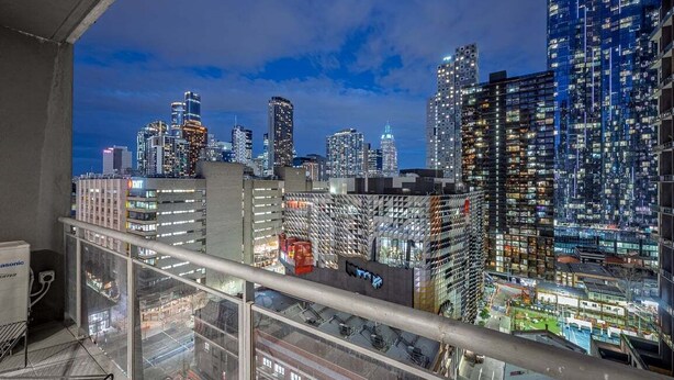 A high-rise building with a modern architectural design, featuring a mix of glass and steel facades. - Convenient CBD Retreat in the Best Location! 2 Bed | 2 Bath | 2 Parking (Melbourne)