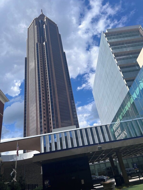 A modern building with a tall, rectangular structure and a glass facade.