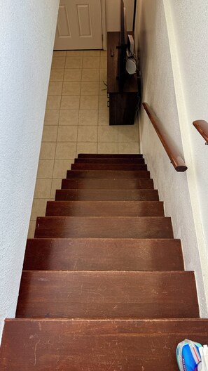 A wooden staircase with a handrail, leading to a door. - 4 Blocks to beach-Fenced Yard-Firepit-Dogs OK W/No Fee- Close to Cruise Terminal (Galveston)