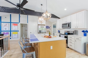 A modern kitchen with white cabinets, a central island, a ceiling fan, and a chandelier. - 2 King Masters, 3 Bed / 3 Bath,  Fire Pit, Walk to Downtown (Mount Airy)